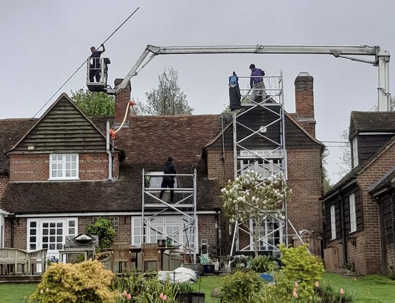 The Roof Moss Cleaners using cherry picker and scaffolding to clean roof safely and professionally in Sandy, Bedfordshire