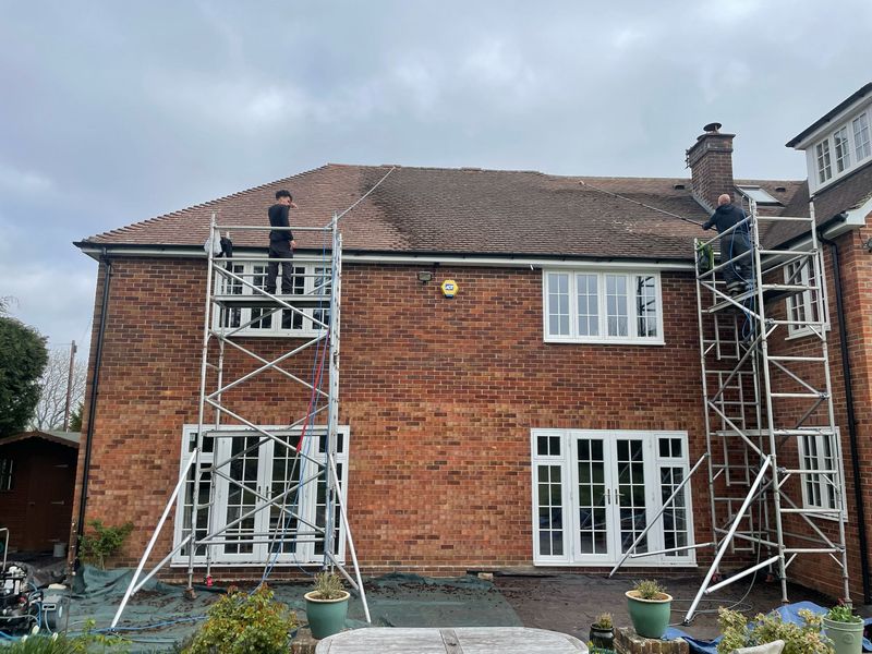 Roof cleaning carried out safely from scaffold towers by The Roof Moss Cleaners in Sandy